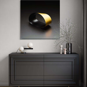 Black Loop
A striking black infinity loop with dramatic contrast on a light background, hanging above a bureau.